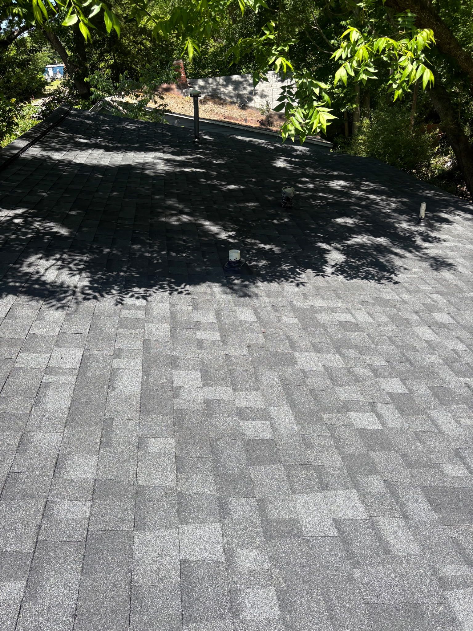 Completed asphalt-shingle roof viewed from the ridge.