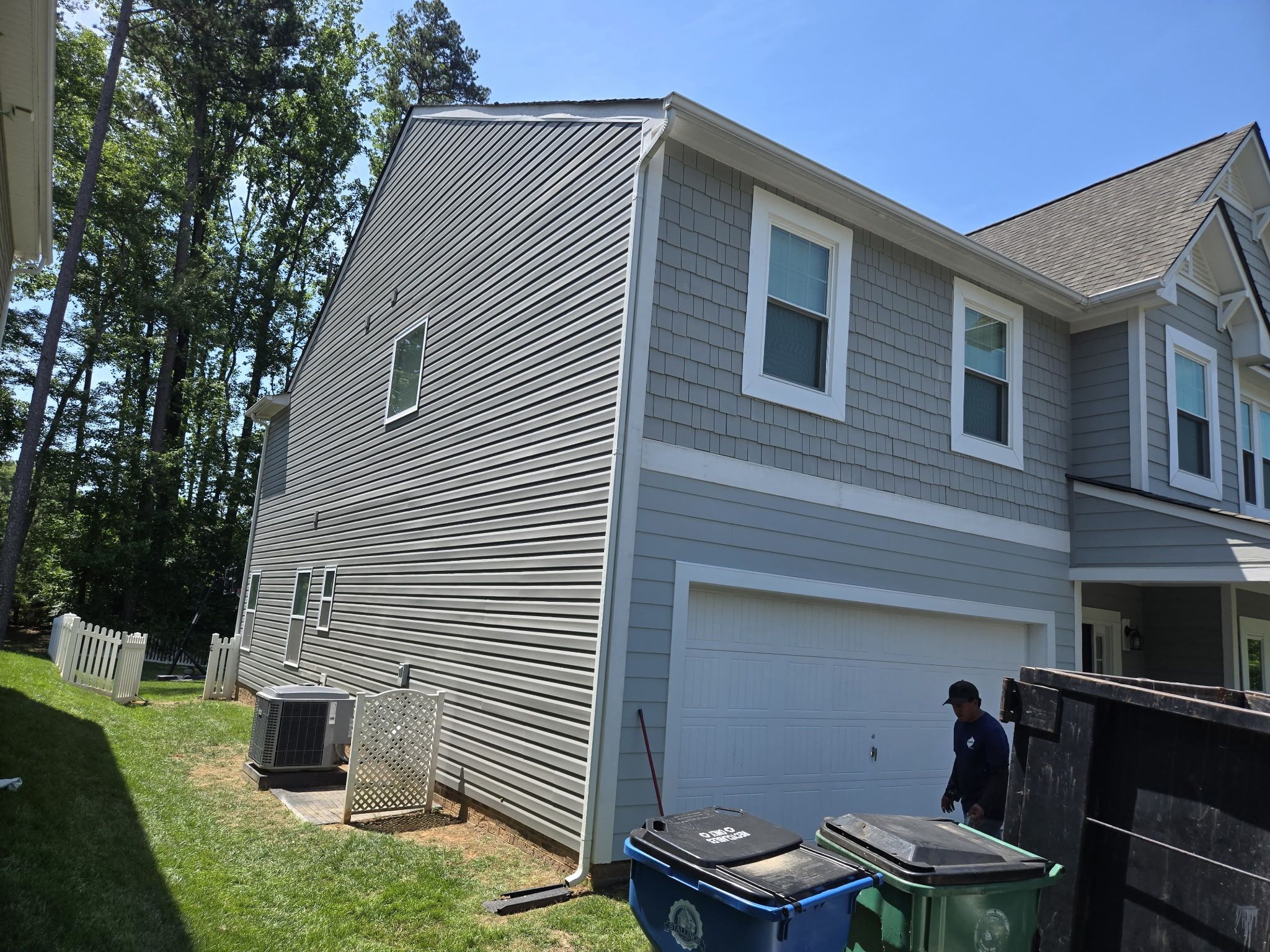 Gray siding on a two-story home with white trim.