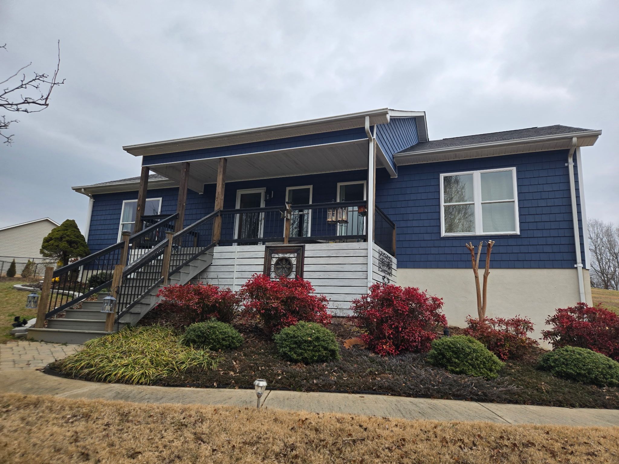 Blue siding and white trim on the front of a home.